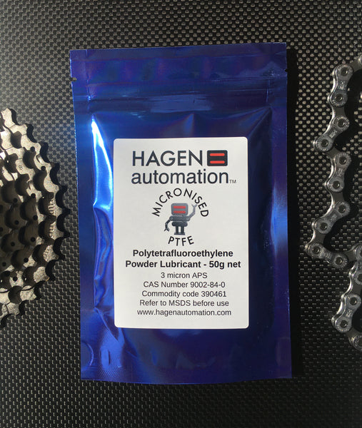 PFTE Powder lubricant 50g Hagen Automation for chain waxing Blue foil pack on carbon fibre with chain and chainring shimano background